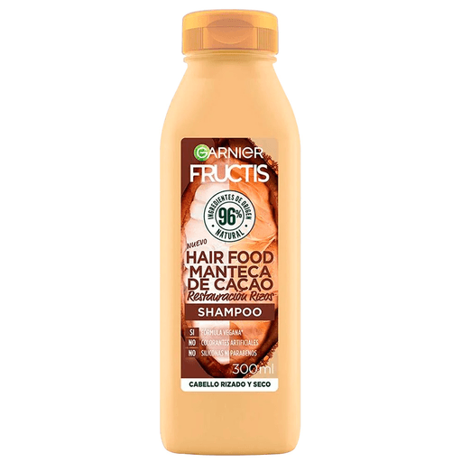 Shampoo Hair Food enriquecido con Manteca de Cacao para cabello rizado y seco. Su fórmula ligera limpia suavemente y nutre el cabello, con rizos, dejándolos saludables, intensamente nutridos, con movimiento, sin efecto pesado y libres de frizz.